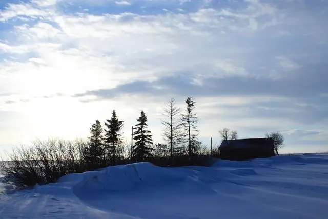Winter sunrise over snowy prairie